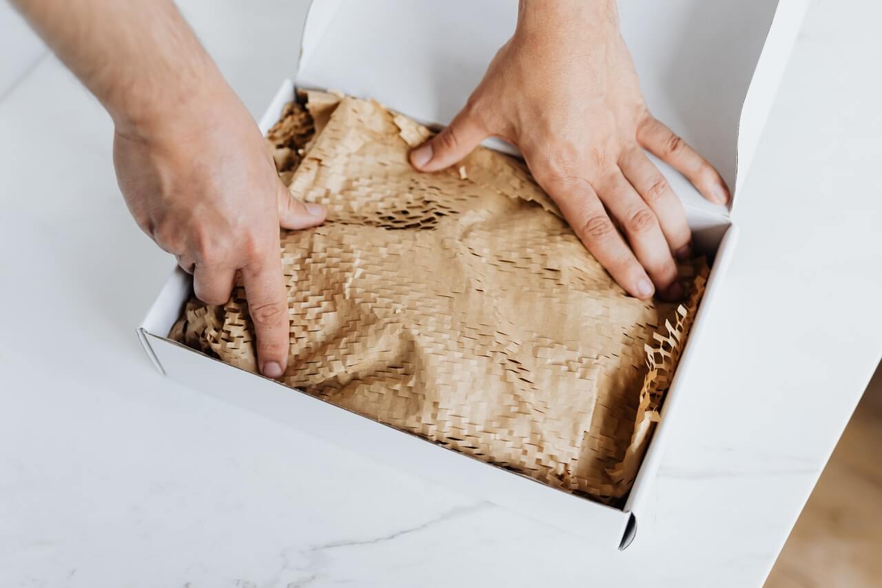 anonymous man preparing package for shipment 4464482